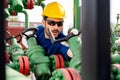 Oil worker turning valve on oil rig Royalty Free Stock Photo