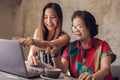 Young and old asian women are using laptop together Royalty Free Stock Photo