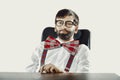 Young old fashioned man sitting by a desk. Royalty Free Stock Photo