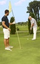 Young and old man golfing together Royalty Free Stock Photo