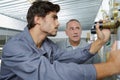 Young and old technician during their work Royalty Free Stock Photo