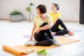 Young and older women doing yoga