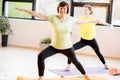 Young and older women doing yoga