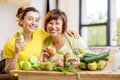 Young and older women with healthy food indoors