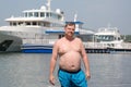 A young oligarch swims in the sea against the background of his own Royalty Free Stock Photo