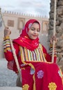 Young omani girl in a red dress on a swing