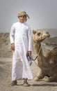 Young omani man with his camel