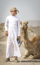 Young omani man with his camel