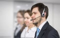 Young operator with headset in call center
