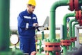 Operator recording operation of oil and gas process at oil and rig plant Royalty Free Stock Photo