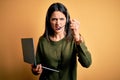 Young operator woman with blue eyes working on call center using computer laptop and headset annoyed and frustrated shouting with Royalty Free Stock Photo