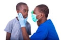 Young ophthalmologist examining the eyes of a little boy