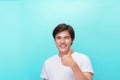 Young optimistic man isolated on blue background showing thump up with positive emotions of content and happiness. Concept of Royalty Free Stock Photo