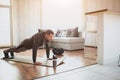 Young ordinary man go in for sport at home. Full size picture of regular ordinary guy stand in plank position alone in Royalty Free Stock Photo