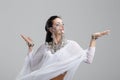 Young oriental princess belly dancing on gray portrait Royalty Free Stock Photo