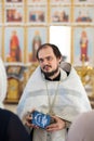 Orenburg, Russian Federation-2 Aprel 2019. A young Orthodox priest holds a certificate of baptism in his hands