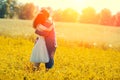 Young ouple hugging in the meadow