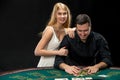 Young ÃÂouple playing poker. Man taking poker chips after winning