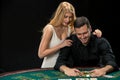 Young ÃÂouple playing poker. Man taking poker chips after winning