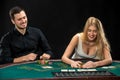 Young ÃÂouple playing poker, woman taking poker chips after winning