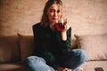 Young woman drinking tea while sitting on sofa at home Royalty Free Stock Photo