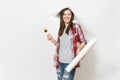 Young overjoyed beautiful woman in casual clothes and newspaper hat holding paint brush and wallpaper roll isolated on Royalty Free Stock Photo