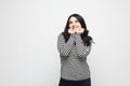 Young oversized woman with dark curly hair wearing striped shirt over white background