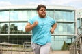 Young overweight man running. Fitness lifestyle