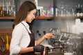 Young owner barista preparing steaming milk with coffee machine Royalty Free Stock Photo