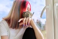 Young owner with pet and degu squirrel. Teenage girl looking out the window Royalty Free Stock Photo
