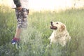 Young owner teacheing his dog the game of stick