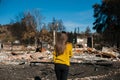 Woman lookinh at her burned home after fire disaster Royalty Free Stock Photo