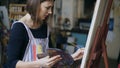 Young painter girl in apron painting still life picture on canvas in art-class Royalty Free Stock Photo