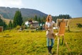 Young painter at work in the mountains