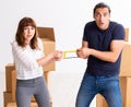 Young pair and many boxes in divorce settlement concept