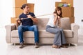 Young pair and many boxes in divorce settlement concept