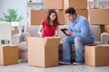 The young pair moving in to new house with boxes Royalty Free Stock Photo