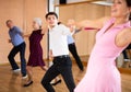 Young pair practicing Latino dance in dance studio