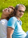 Young pair sits on a grass