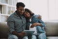 Young Pakistani Man with Pregnant Wife on Sofa. Royalty Free Stock Photo