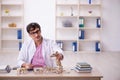 Young male paleontologist examining ancient animals at lab Royalty Free Stock Photo