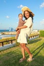 Mother and child in front of Greek flag blowing in the wind Royalty Free Stock Photo