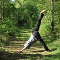 Girl exercising yoga pose three-legged downward dog