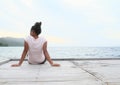 Girl sitting on jetty by sea Royalty Free Stock Photo