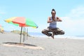 Girl levitating in yoga pose on beach