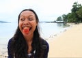 Young Papuan woman with tongue red from betel
