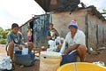 Young paraguayan women wash clothes by hand