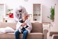 Young paramedic visiting old man at home Royalty Free Stock Photo