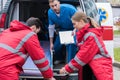 young paramedics moving ambulance stretcher