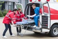 young paramedics moving out ambulance stretcher Royalty Free Stock Photo